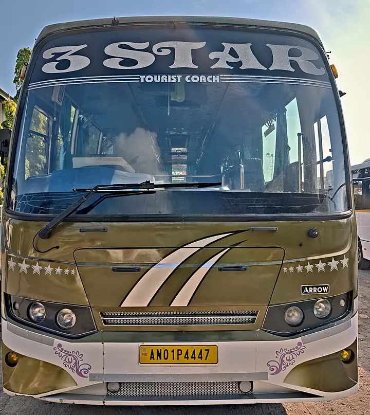 Front of a gold 3 Star tourist coach with the company name across the windscreen
