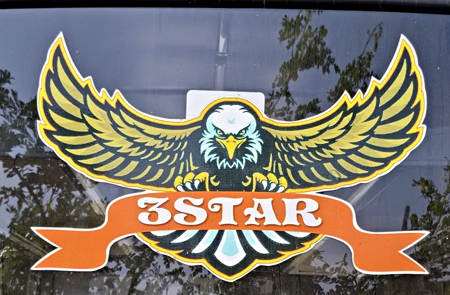 The 3 Star eagle emblem on the rear window of one of our buses