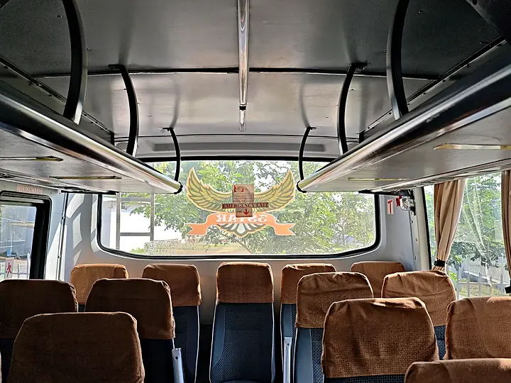 Inside a 3 Star coach: rows of cushioned seats and luggage racks, with the 3 Star logo on the rear window
